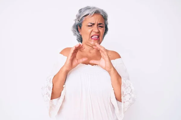 Senior hispanic grey- haired woman wearing casual clothes disgusted expression, displeased and fearful doing disgust face because aversion reaction. with hands raised