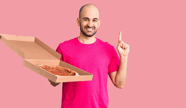 Young Handsome Man Holding Delivery Pizza Cardboard Box Surprised Idea — Stock Photo, Image