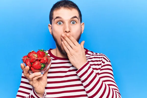 Young Handsome Man Holding Bowl Strawberries Covering Mouth Hand Shocked — Stock Photo, Image