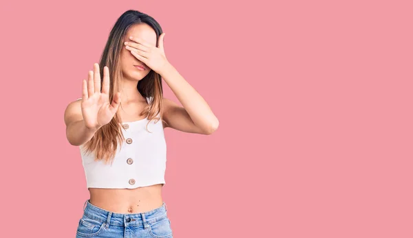 Young Beautiful Girl Wearing Casual Sleeveless Shirt Covering Eyes Hands — Stock Photo, Image