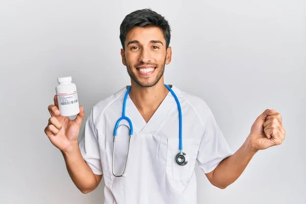 Young Handsome Man Wearing Doctor Uniform Holding Presciption Pills Screaming — Stock Photo, Image