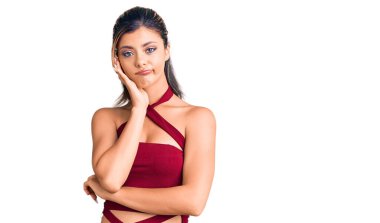 Genç ve güzel bir kadın günlük kıyafetler giyip kollarını kavuşturarak depresyondan sıkılmış ve yorgun görünüyor.. 