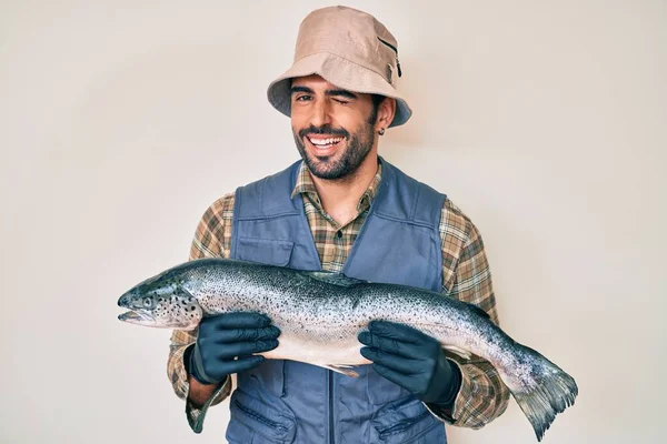 Handsome Hispanic Man Beard Showing Raw Salmon Winking Looking Camera — Stock Photo, Image