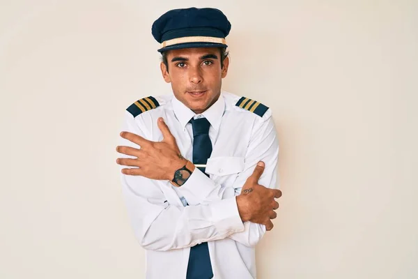 Young Hispanic Man Wearing Airplane Pilot Uniform Shaking Freezing Winter — Stock Photo, Image