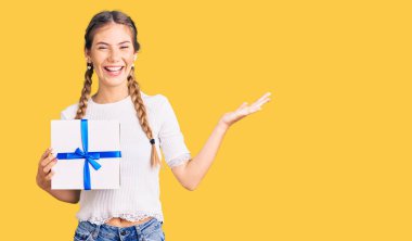 Sarışın, güzel, beyaz bir kadın zaferi mutlu bir gülümsemeyle ve ellerini kaldırarak kutluyor. 