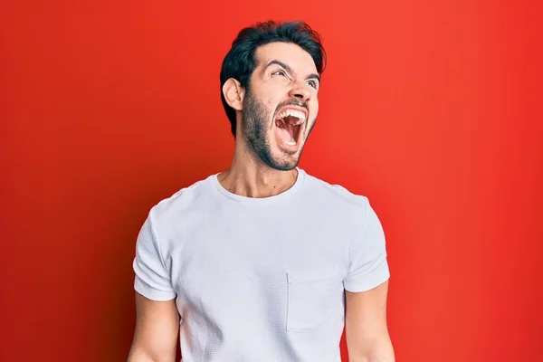 Young Hispanic Man Wearing Casual White Tshirt Angry Mad Screaming — Stock Photo, Image