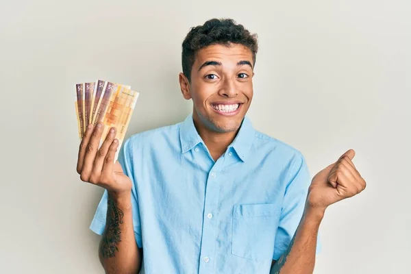 Joven Hombre Afroamericano Guapo Sosteniendo 500 Billetes Noruegos Gritando Orgulloso —  Fotos de Stock