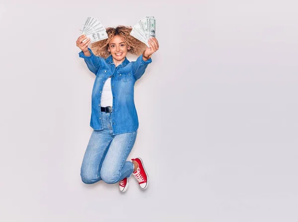 Young Beautiful Curly Girl Smiling Happy Holding Dollars Banknotes Jumping — Stock Photo, Image