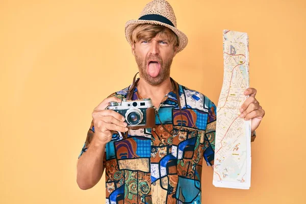 Young Blond Man Holding Vintage Camera City Map Sticking Tongue — Stock Photo, Image