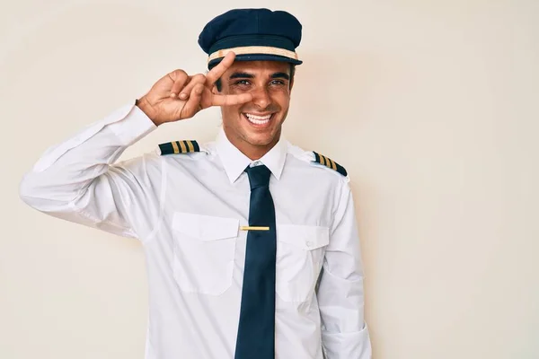 Young Hispanic Man Wearing Airplane Pilot Uniform Doing Peace Symbol — Stock Photo, Image