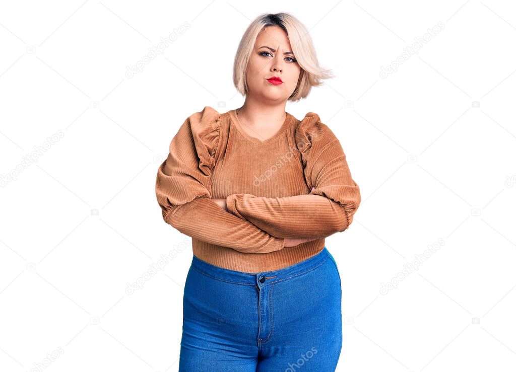 Young blonde plus size woman wearing casual sweater skeptic and nervous, disapproving expression on face with crossed arms. negative person. 