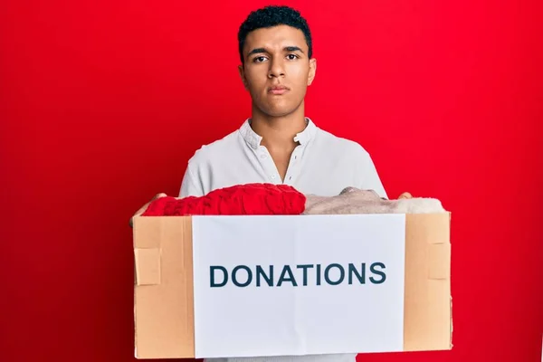 Young Arab Man Holding Donation Box Clothes Skeptic Nervous Frowning — Stock Photo, Image