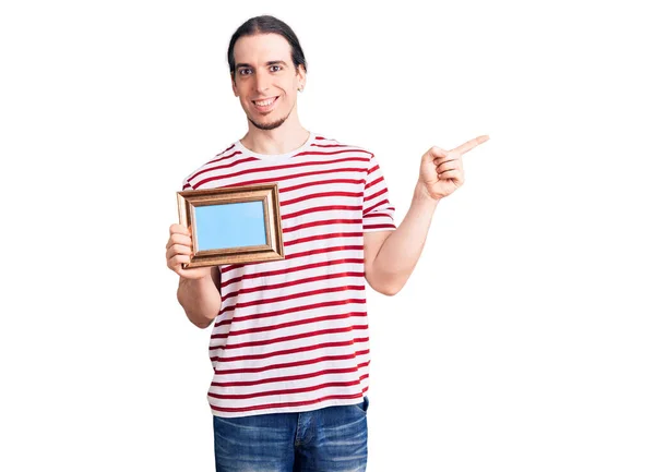 Young Adult Man Long Hair Holding Empty Frame Smiling Happy — Stock Photo, Image