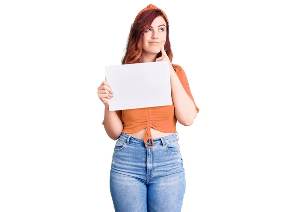 Young Beautiful Woman Holding Cardboard Banner Blank Space Serious Face — Stock Photo, Image