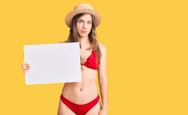 Beautiful Caucasian Young Woman Wearing Bikini Holding Blank Empty Banner — Stock Photo, Image