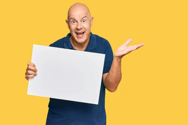 Middle Age Bald Man Holding Blank Empty Banner Celebrating Victory — Stock Photo, Image