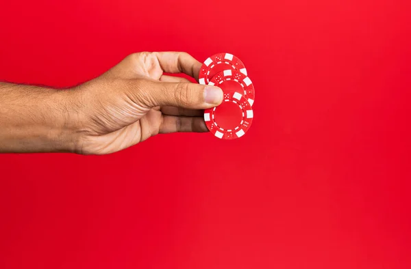 Hand Hispanic Man Holding Casino Chips Isolated Red Background — Stock Photo, Image