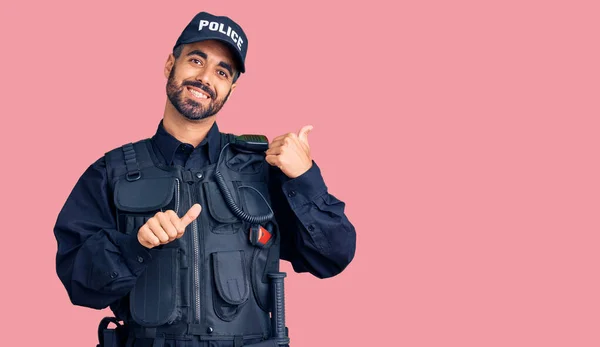 Young Hispanic Man Wearing Police Uniform Pointing Back Hand Thumbs — Stock Photo, Image