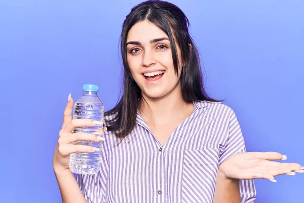Young Beautiful Girl Holding Bottle Water Celebrating Achievement Happy Smile — Stock Photo, Image
