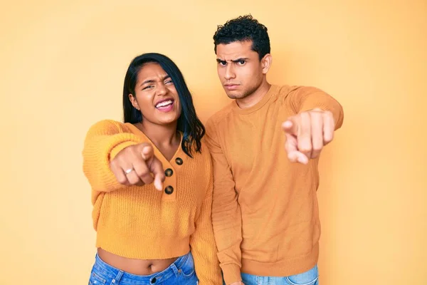 Beautiful Latin Young Couple Wearing Casual Clothes Together Pointing Displeased — Stock Photo, Image