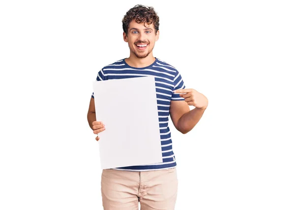 Young Handsome Man Curly Hair Holding Blank Empty Banner Smiling — Stock Photo, Image