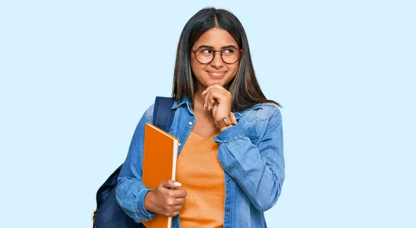 Joven Chica Latina Usando Mochila Estudiante Sosteniendo Libros Pensando Preocupado —  Fotos de Stock