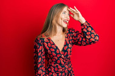 Zarif bir elbise giyen güzel, genç, sarışın bir kadın. Çok mutlu ve gülümsüyor. Çok uzaklara bakıyor. arama kavramı. 