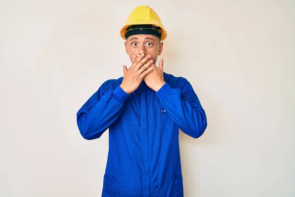 Young Hispanic Boy Wearing Worker Uniform Hardhat Shocked Covering Mouth — Stock Photo, Image