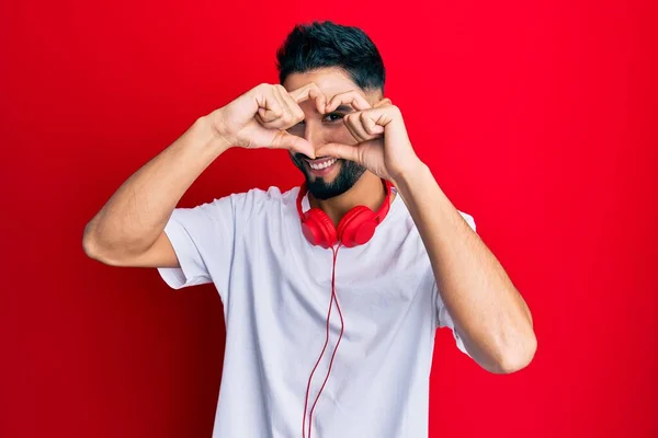 Young Man Beard Listening Music Using Headphones Doing Heart Shape — Stock Photo, Image