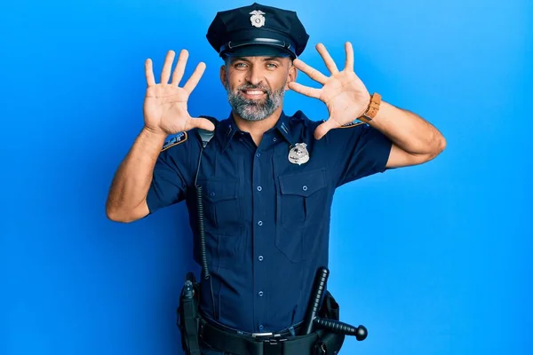 Middle age handsome man wearing police uniform showing and pointing up with fingers number ten while smiling confident and happy.
