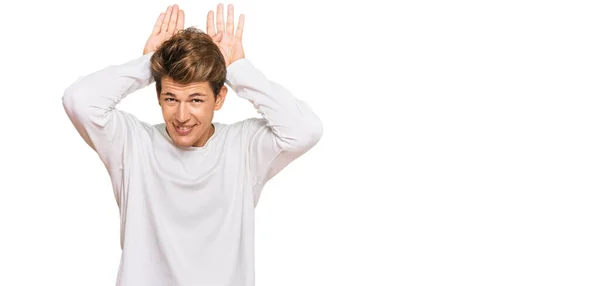 Handsome Caucasian Man Wearing Casual White Sweater Doing Bunny Ears — Stock Photo, Image