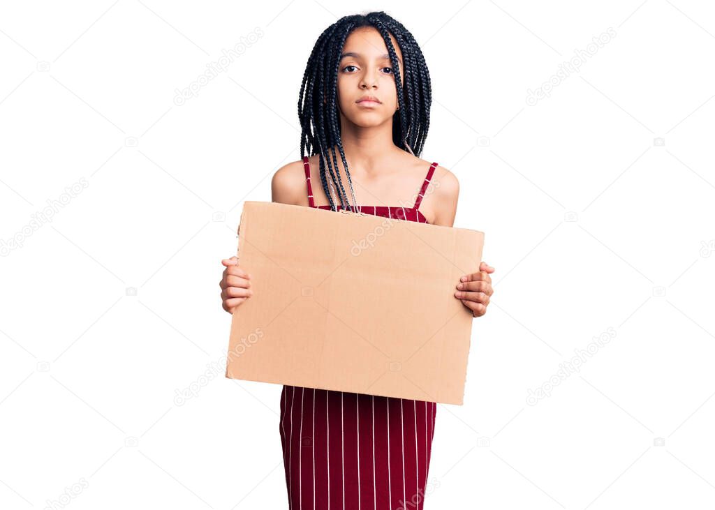 Cute african american girl holding empty banner thinking attitude and sober expression looking self confident 
