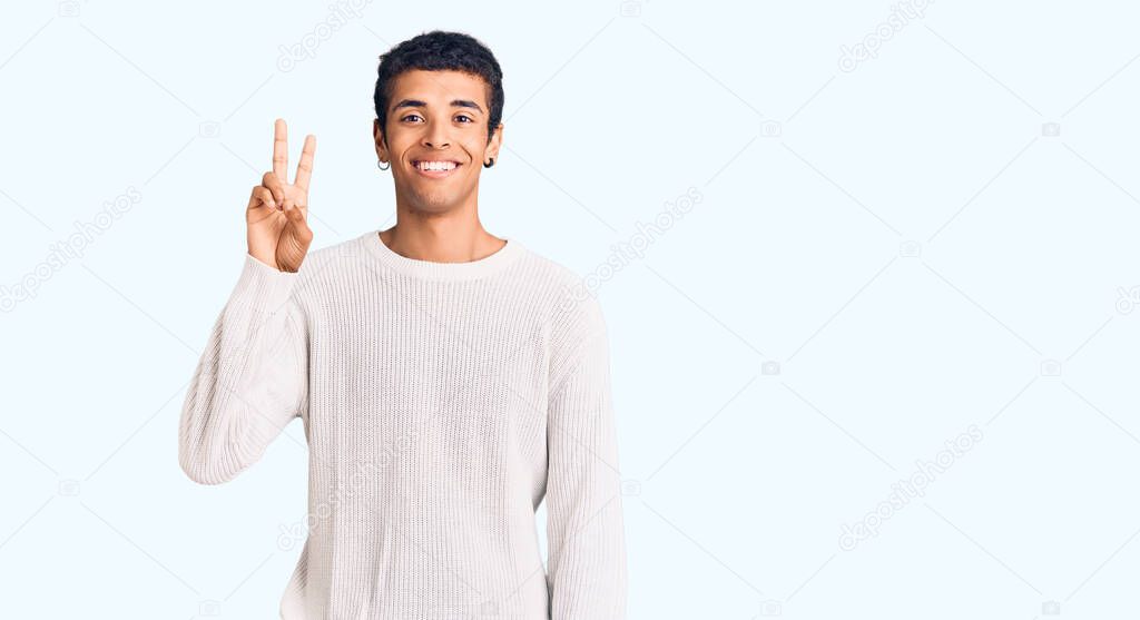 Young african amercian man wearing casual clothes showing and pointing up with fingers number two while smiling confident and happy. 
