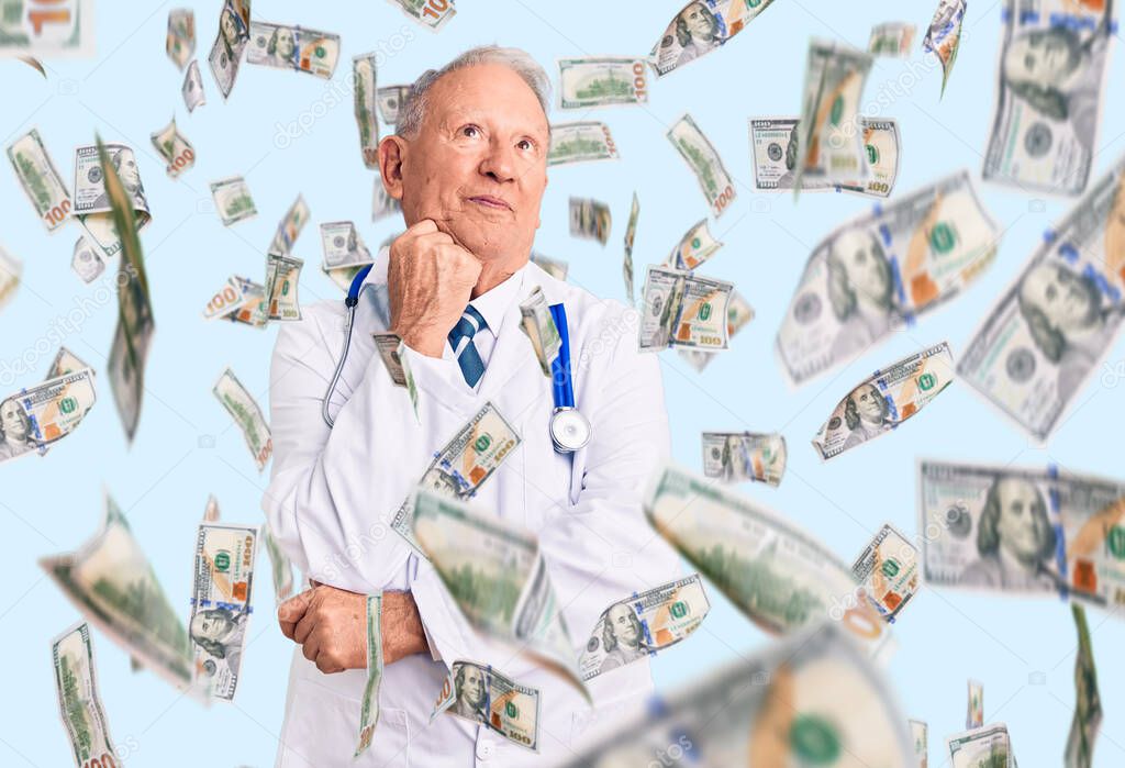 Senior handsome grey-haired man wearing doctor coat and stethoscope with hand on chin thinking about question, pensive expression. smiling and thoughtful face. doubt concept.