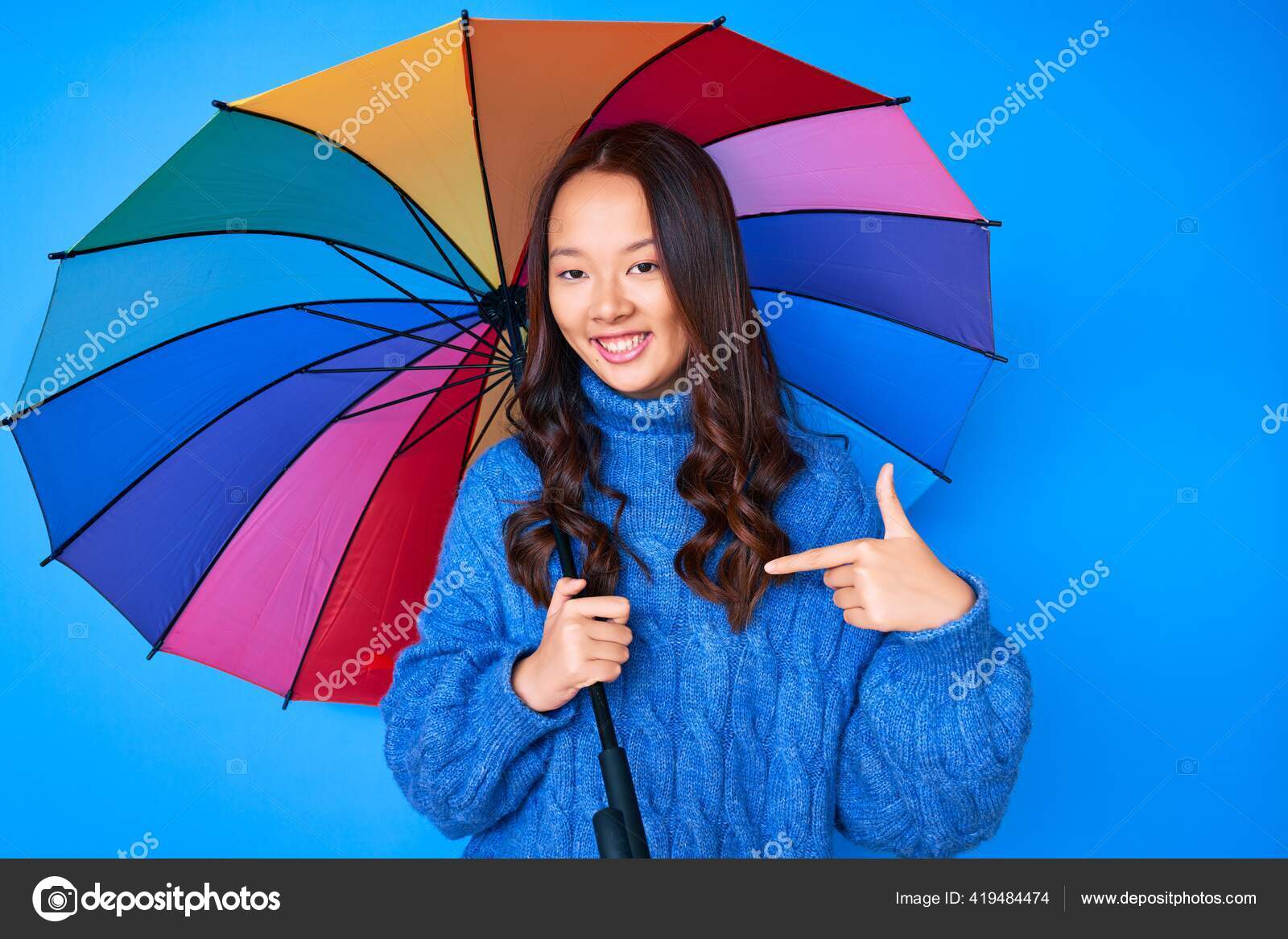 Joven Hermosa Chica China Sosteniendo Colorido Paraguas Apuntando Dedo Uno: fotografía de © Krakenimages.com #419484474 | Depositphotos