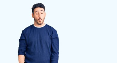 Gündelik kıyafetler giyen genç İspanyol adam dudaklarıyla balık suratı yapıyor, çılgınca ve komik bir jest. Komik ifade. 