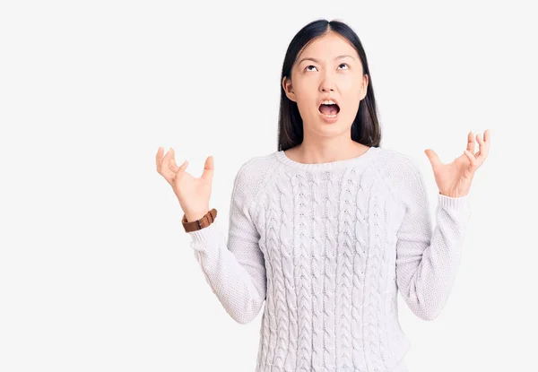 Young Beautiful Chinese Woman Wearing Casual Sweater Crazy Mad Shouting — Stock Photo, Image