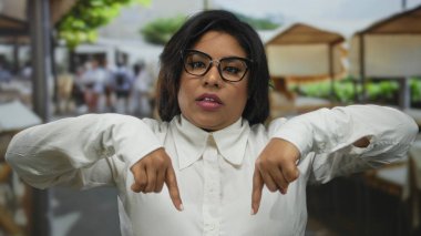 Şehir merkezindeki sokak manzarasına dikkat çeken kadın, şehir arka planındaki açık havaya odaklı dışa dönük hareketler sergiliyor..