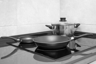 Pan on modern electric stove in the kitchen clipart
