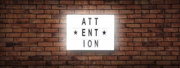 attention letterboard text -  background with copy space on red bricks wall
