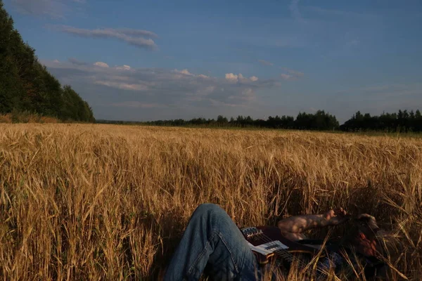 Legs of a man lying in a rye field — Stock Photo, Image