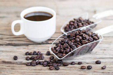 Beyaz kahve fincanı ile kavrulmuş kahve çekirdekleri