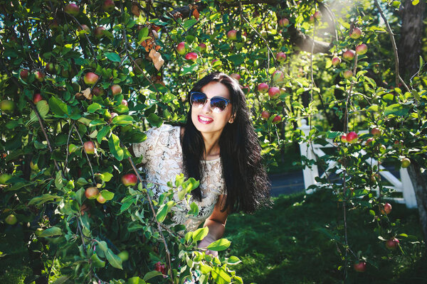 Beautiful young woman in apple trees