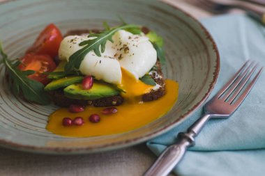 avokado, haşlanmış yumurta, roka ve domates sandviç