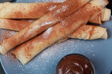 Krep ile çilek, reçel, bal ve çikolata, toz şeker ve tarçın ile serpilir