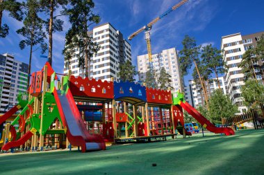 yüksek katlı binalar arasındaki parkta çocuklar için çok renkli oyun alanı