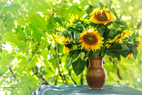 beautiful yellow sunflowers in a vase on the table