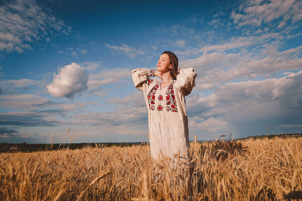 teenager in an embroidered dress in nature