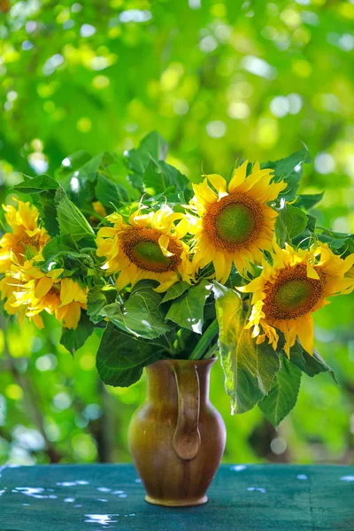 beautiful yellow sunflowers in a vase on the table