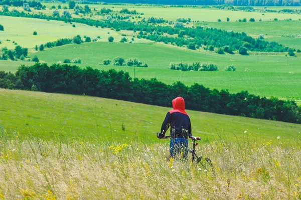 young man cycling in a field
